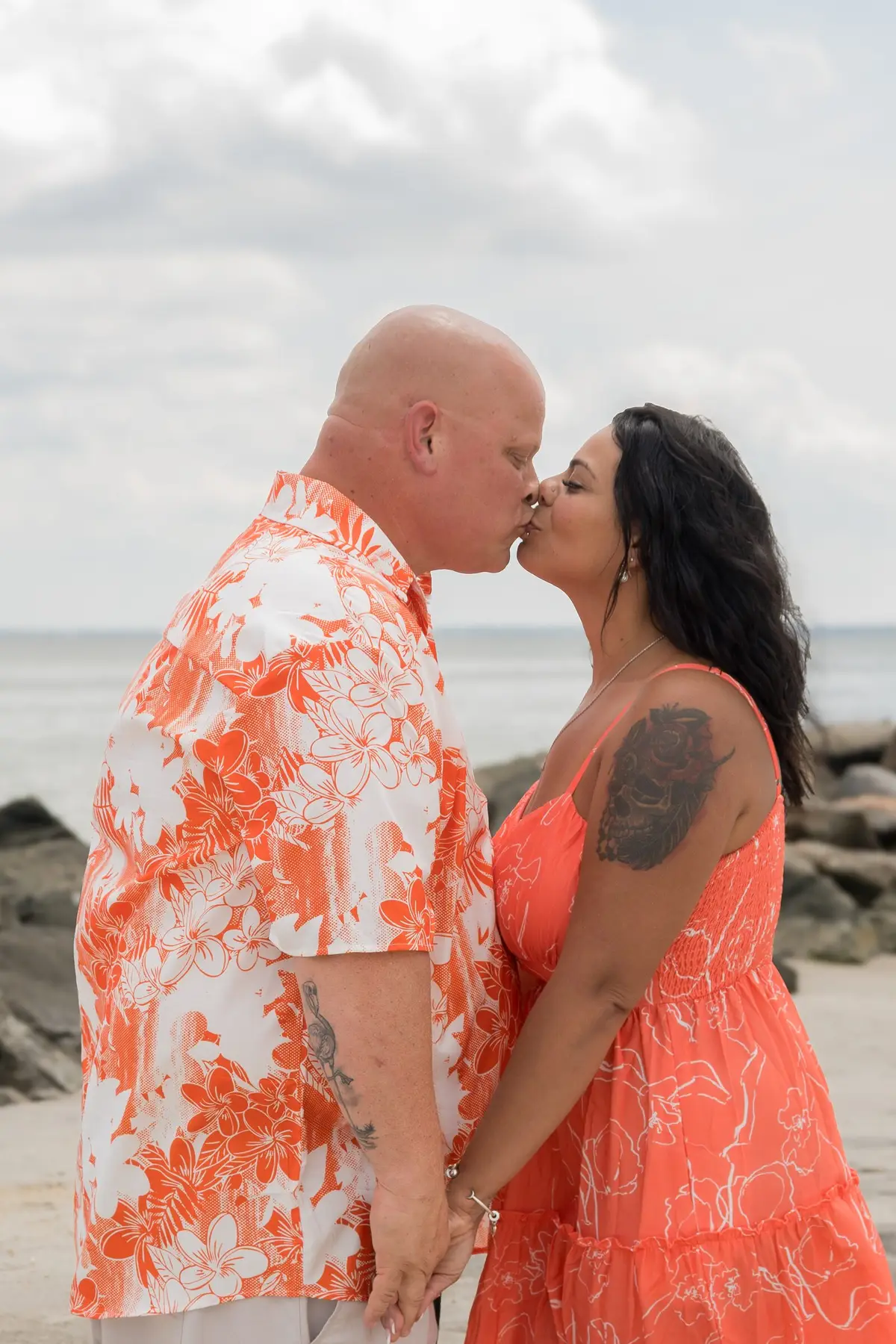 Couple standing on a pier by the water