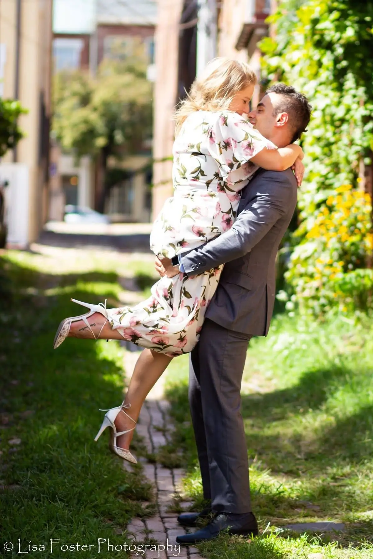 Engagement portrait against a brick wall