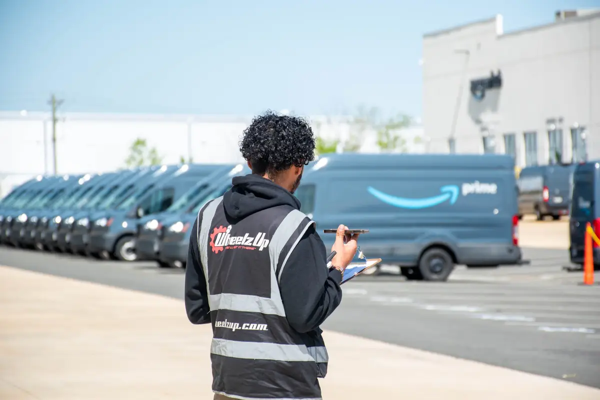 Delivery driver in a cap, seated for a portrait