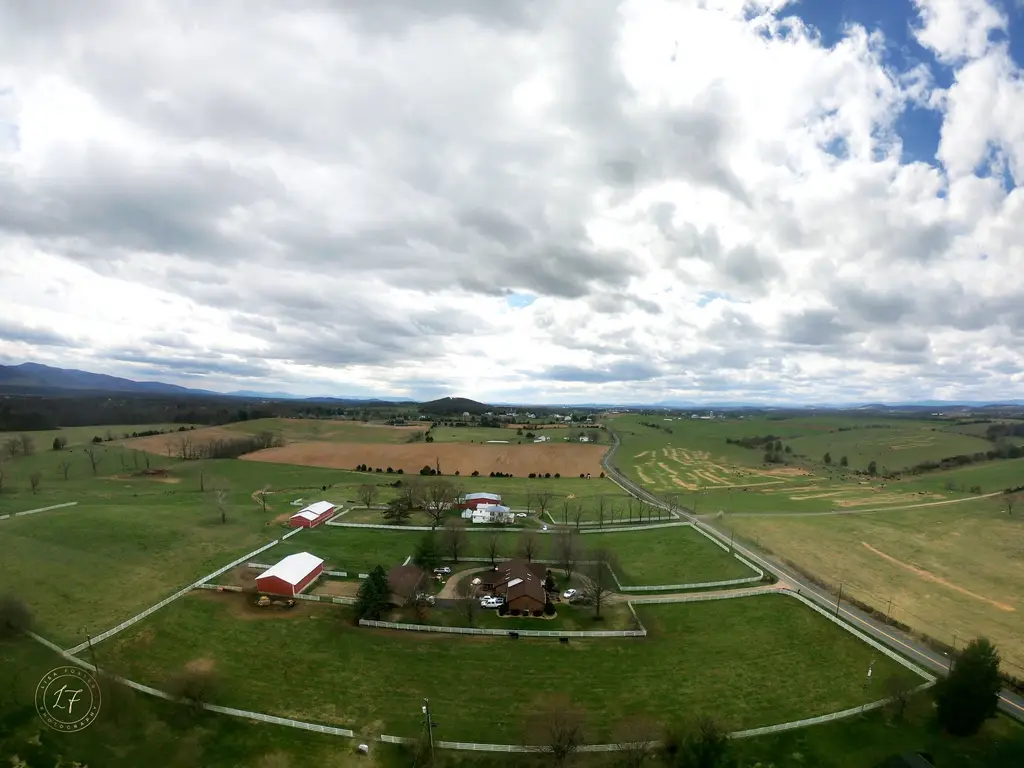 Aerial view of green farmland and barns