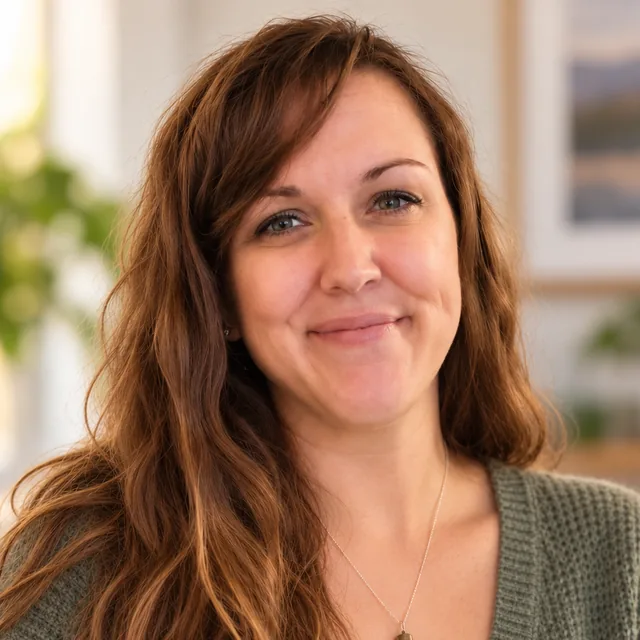 Lisa Foster, photographer, smiling in a green sweater