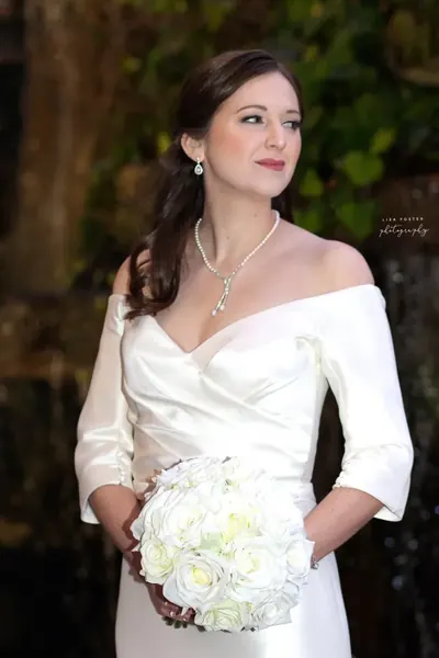 Bride in a white gown holding a white bouquet