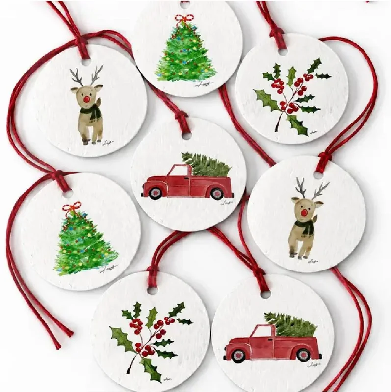 Eight round seed-paper gift tags on red string with trees, holly, deer, and a red truck carrying a tree.