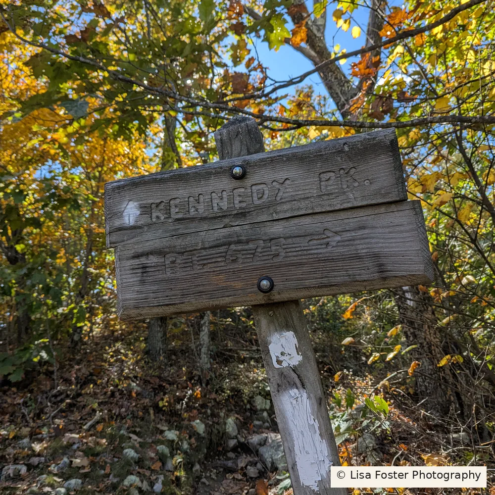 White blaze on the wooden Kennedy Peak trail sign post where the spur begins