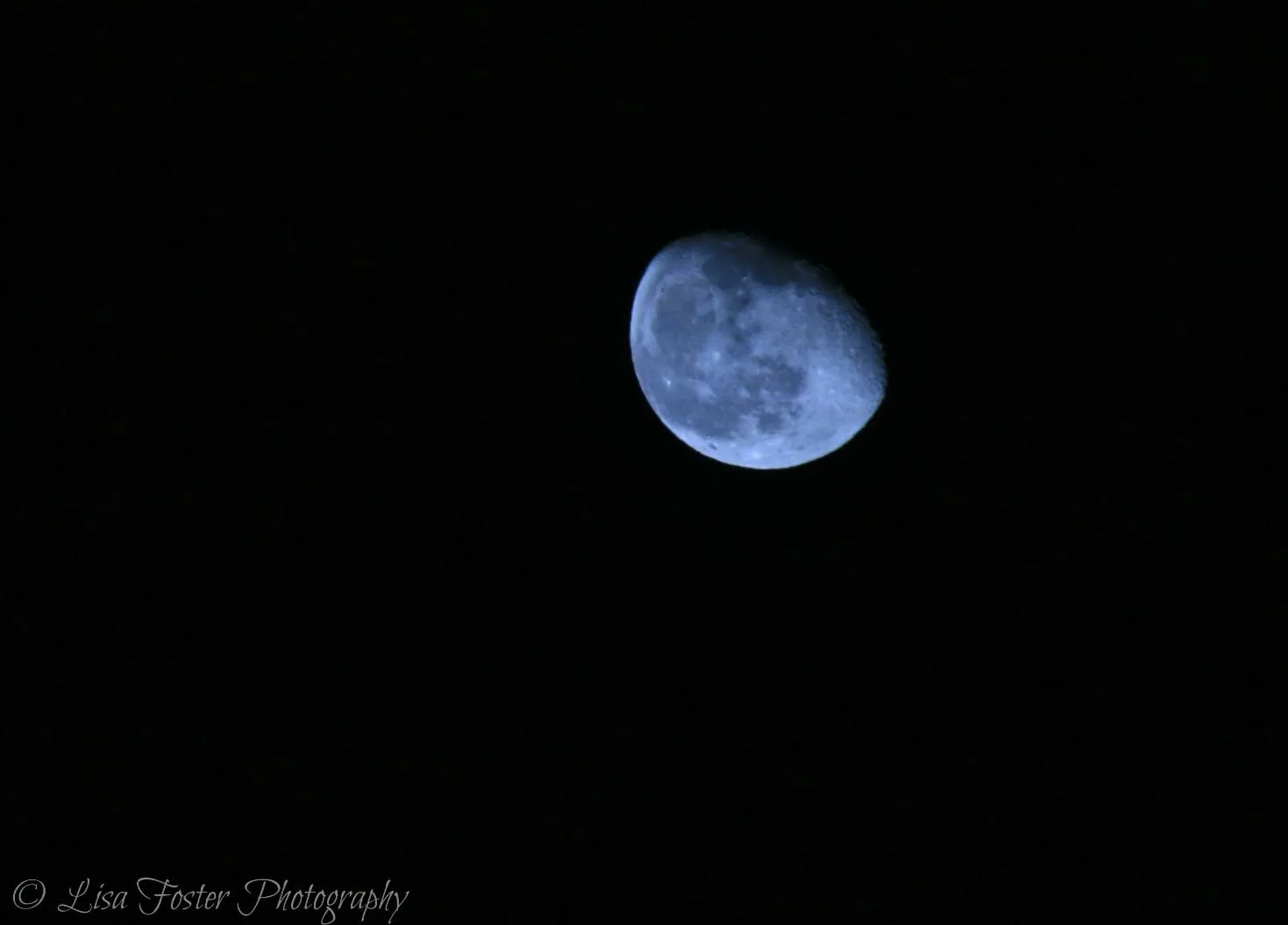 The Moon, a little past half full, glowing against a black sky