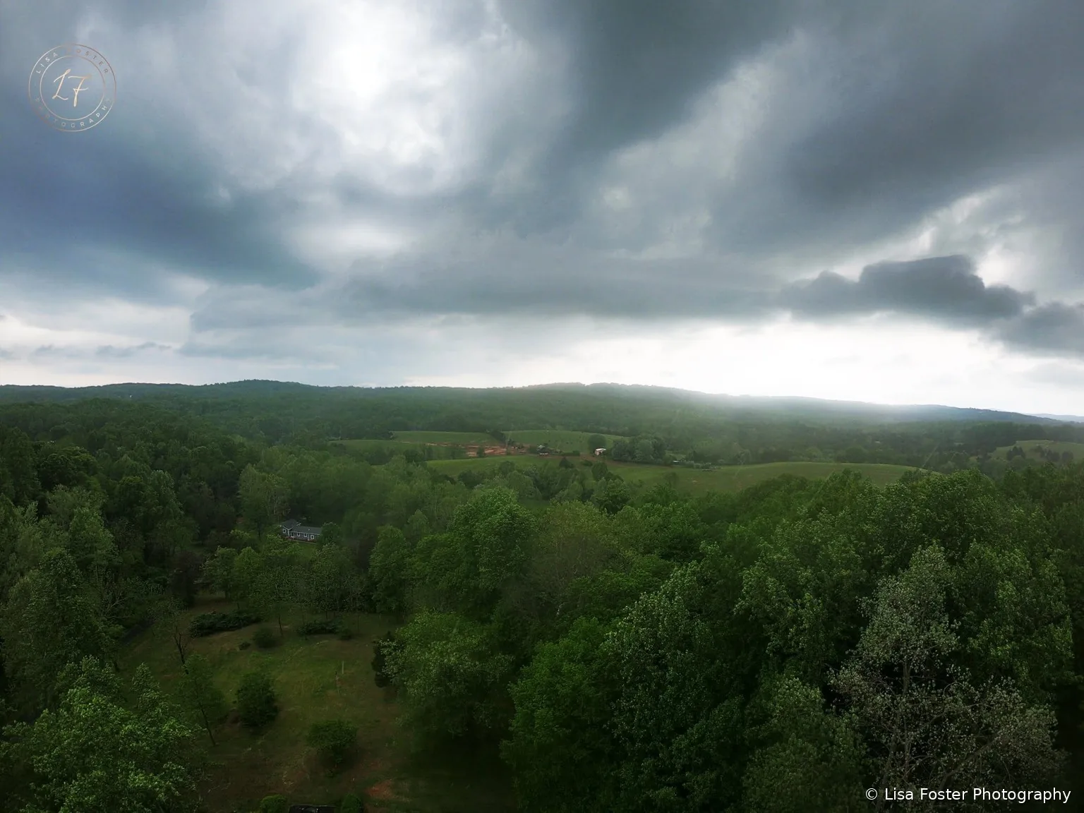 A forested Blue Ridge valley under a big cloudy sky