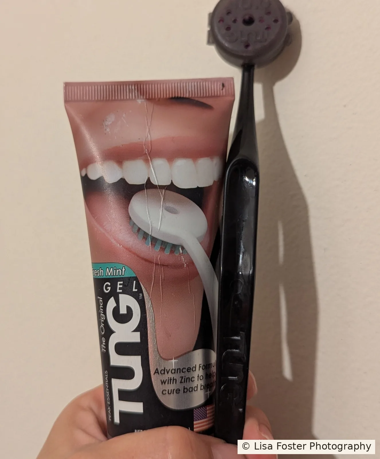 The Original Tung Gel beside a black Tung tongue brush.